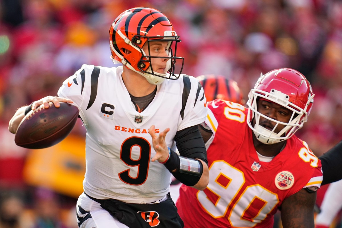 Jan 30, 2022; Kansas City, Missouri, USA; Cincinnati Bengals quarterback Joe Burrow (9) looks to pass the ball as Kansas City Chiefs defensive tackle Jarran Reed (90) pursues during the first quarter of the AFC Championship Game at GEHA Field at Arrowhead Stadium. Mandatory Credit: Jay Biggerstaff-USA TODAY Sports